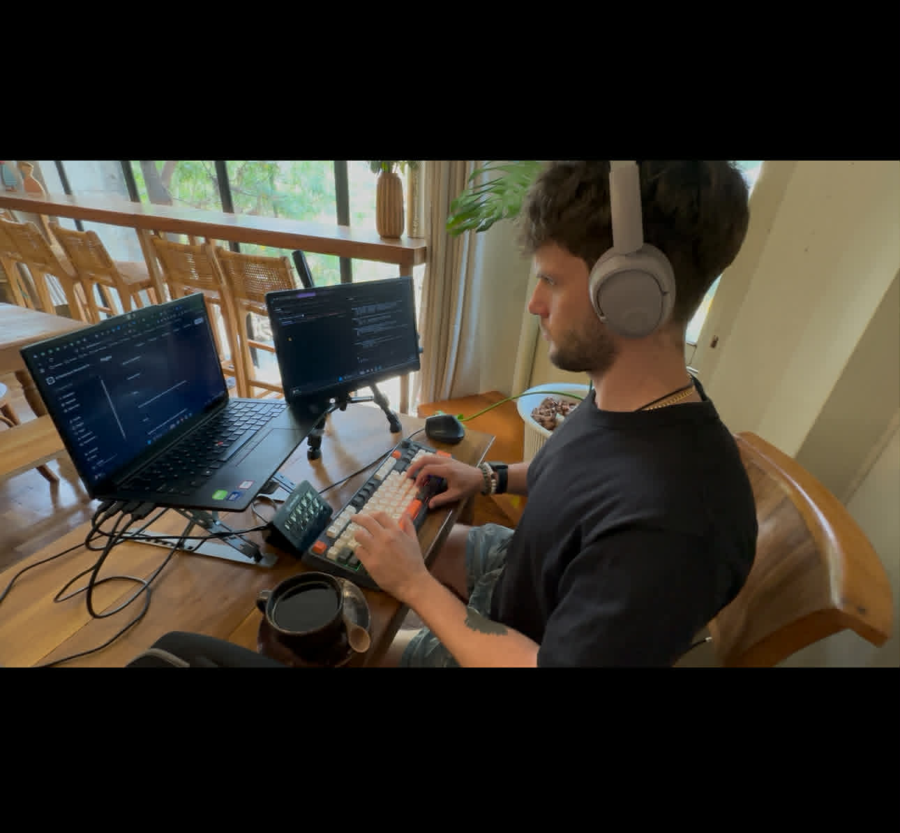 Working from a co-working space in Chiang Mai — laptop, portable second monitor, mechanical keyboard.